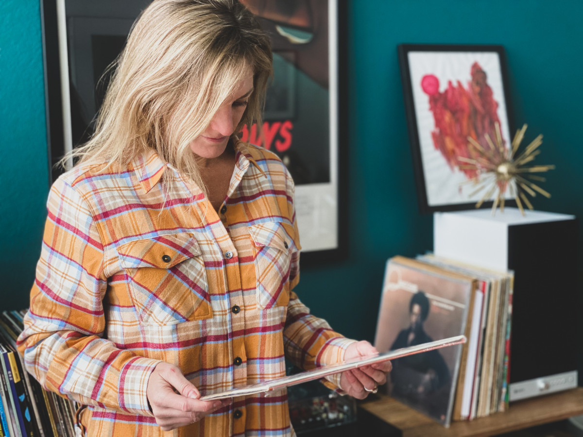 Laura wears the Women's California Cowboy High Sierra Shirt - perfect for après ski or just digging through your vinyl collection on a snowy Sunday